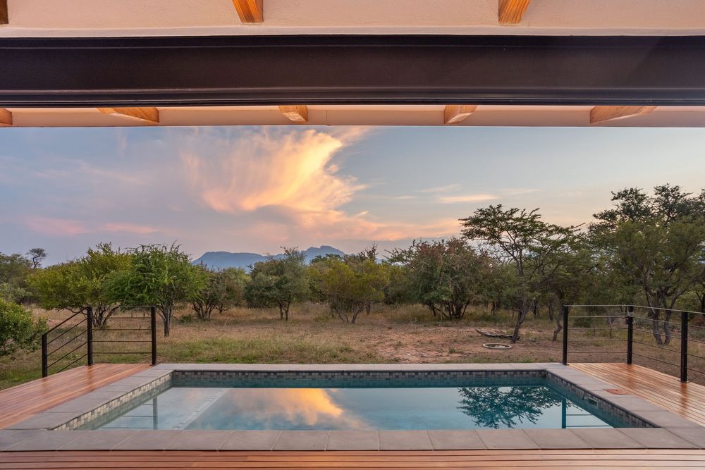 Villa entertainment area opening onto the garden at dusk
